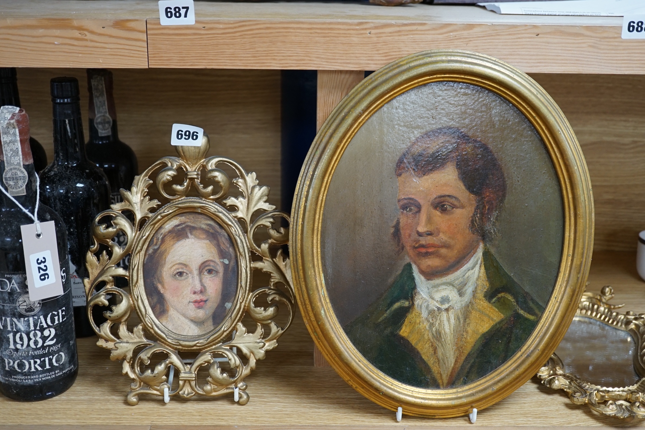 Early 19th century, oval oil on board, Portrait of a gentleman, together with another portrait of a lady, housed in a gilt metal frame, and an Italian rococo style gilt framed wall mirror, largest 28 x 22cm. Condition -